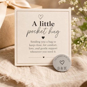May include: A beige card with the words "A little pocket hug" and a silver pocket token. The card contains a message about comfort and support. The token features a heart and the initials "S & K".