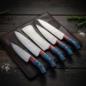 A collection of five Damascus steel kitchen knives with red and blue handles, presented on a brown leather case. The blades feature a distinctive patterned design. The handles are a vibrant blue with red accents.