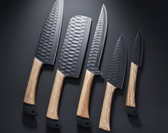 May include: A set of five kitchen knives with textured, dark gray blades and light wood handles. The knives vary in size and shape, including a cleaver and a paring knife. The handles have a black base.