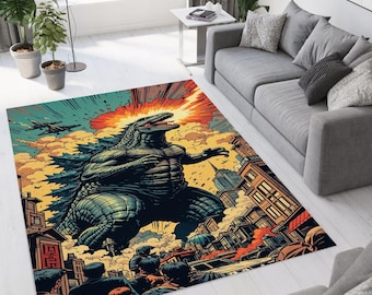 May include: A rectangular area rug featuring a Godzilla illustration in a comic book style. The rug depicts Godzilla in a city setting with explosions, planes, and a crowd of people. The color palette includes shades of blue, orange, and yellow.