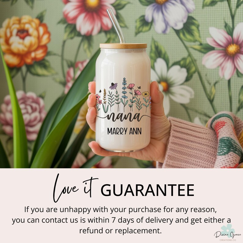 May include: A white glass can-shaped tumbler with a bamboo lid and straw. The tumbler features a floral design with the word "nana" and the name "Marry Ann" in black script. The background is a floral wallpaper.