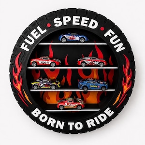 May include: A circular wall display shelf shaped like a black tyre with a flame pattern background. The frame features the white text FUEL SPEED FUN and BORN TO RIDE. Four white horizontal shelves hold six small toy race cars of various colours.