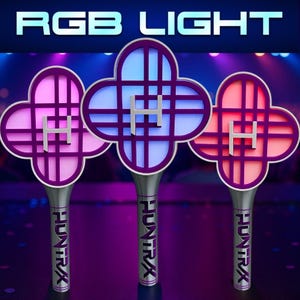 May include: Three RGB light wands with a four-leaf clover design. Each wand has a different color: pink, blue, and red. The wands have a silver handle with the text "HUNTRAX". The top of the wands have the letter "H". The text "RGB LIGHT" is at the top.
