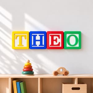 May include: Four square wall-mounted blocks featuring the letters T, H, E, and O in yellow, blue, red, and green. The T is yellow, H is blue, E is red, and O is green. Each block has a white center with horizontal lines.