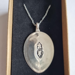 Upcycled silver spoon with a stamped pattern on a sterling silver chain