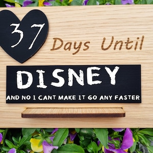 May include: Wooden countdown sign with a heart-shaped chalkboard displaying "37" days until Disney. The sign also features the text "Days Until DISNEY" and "AND NO I CAN'T MAKE IT GO ANY FASTER."