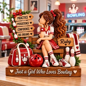 May include: A figurine of a person with brown hair sitting on a wooden bench, surrounded by bowling gear including a red bag, a bowling ball, pins, and shoes. The base features the text "Just a Girl Who Loves Bowling" and a sign reads "PRACTICE, PERSISTENCE, CONFIDENCE, BIG DREAMS".