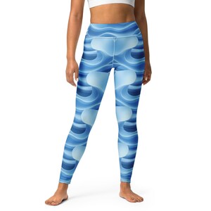 May include: Blue yoga leggings with a repeating wave pattern in shades of blue and white. The high-waisted leggings are made of a stretchy material and are designed for comfort and flexibility during workouts or everyday wear.