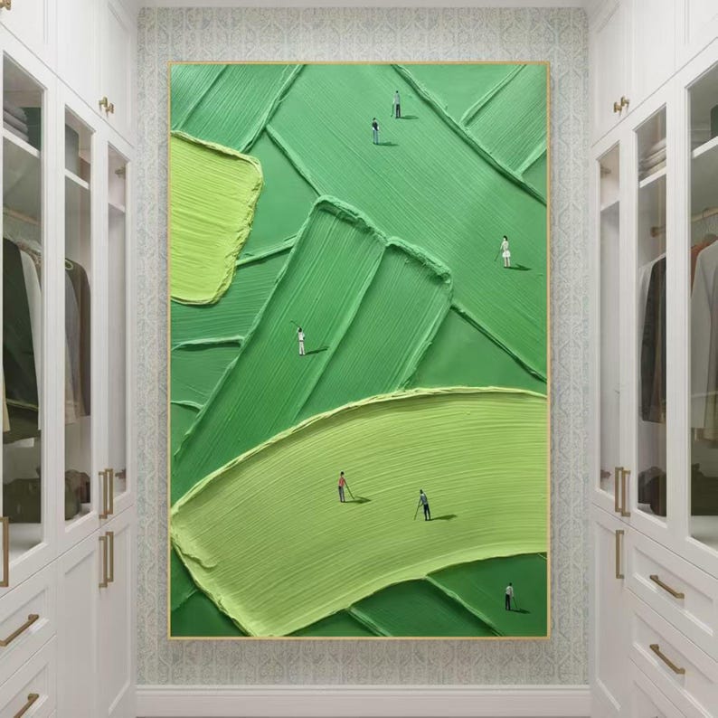 May include: Abstract green golf course painting with textured brushstrokes. The artwork features miniature figures of golfers on the course. The painting is framed in a gold-coloured frame and hangs in a white wardrobe.