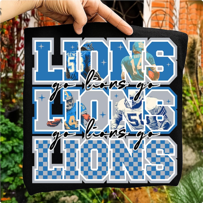 May include: Black t-shirt featuring the word "LIONS" in blue and gray block letters, with the words "go lions go" in cursive. The shirt has images of football players in action.