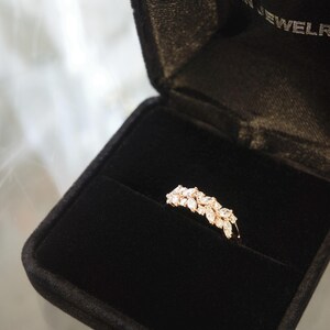 unique women wedding ring with marquise diamond and round diamond