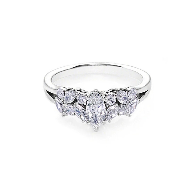 a unique engagement ring set with 0.30ct marquise diamond at the centre and accent marquise cut diamond and round brilliant cut diamond on the side.