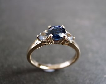 Blue Sapphire and White Sapphire Three Stone Engagement Ring in 14K Yellow Gold