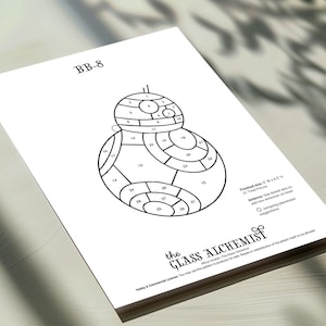 May include: A black and white line drawing of the BB-8 droid from Star Wars, labeled "BB-8". The image is a pattern for glass art, with numbered sections and the text "the GLASS ALCHEMIST". Finished size is 9"W x 4.5"H.