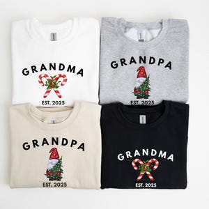 May include: Four sweatshirts with holiday-themed designs. Two sweatshirts say "Grandma" and two say "Grandpa". The designs include candy canes and a gnome holding a Christmas tree. The text "EST. 2025" is also included.