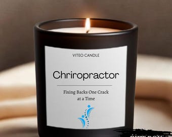 May include: A black glass candle with a white label featuring the text VITEO CANDLE, Chriropractor, Fixing Backs One Crack at a Time, and a blue spinal graphic. The candle has a lit wick and a black rectangular graphic with the text GIFT BOX INCLUDED.