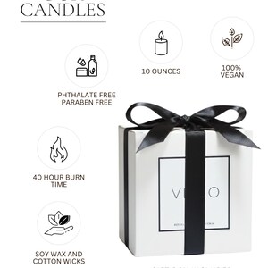 The image is a promotional image for candles, featuring a white box with a black ribbon and a candle inside. The text on the image includes details about the candles, such as their vegan status, the number of ounces, and the fact that they are soy wax and cotton wicks. The image also includes a gift box and a handwritten card for sending a message.