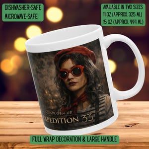 May include: White ceramic mug featuring a woman in a red beret and sunglasses. The mug has the text "CLAIR OBSCUR EXPEDITION 33" and is dishwasher and microwave safe. Available in two sizes: 11 oz (approx. 325 ml) and 15 oz (approx. 444 ml).