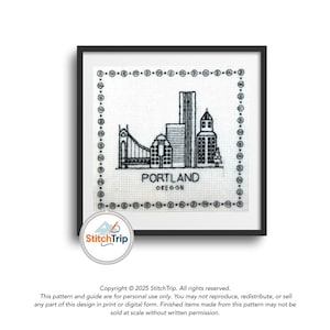 May include: Black and white cross-stitch of the Portland, Oregon skyline, framed in a black square. The design includes a bridge, buildings, and the text "PORTLAND OREGON". The artwork is on a white background.
