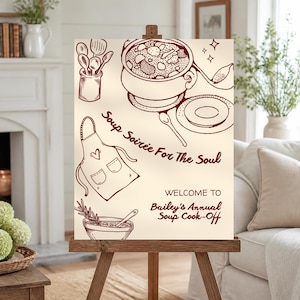 Peut inclure: Une affiche couleur crème sur un chevalet en bois avec des dessins au trait rouge foncé représentant une marmite, une louche, un pot à ustensiles, un tablier et un bol aux herbes. Le texte indique : Soup Soirée For The Soul, WELCOME TO Bailey's Annual Soup Cook-Off.