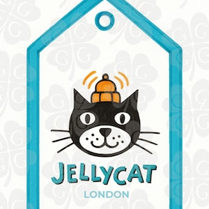 May include: A whimsical illustration featuring a black cat with a small orange hat, set within a blue tag-shaped frame. The text "JELLYCAT LONDON" is displayed below the cat. The background has a repeating clover pattern.