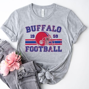 a shirt that says buffalo football with a helmet on it