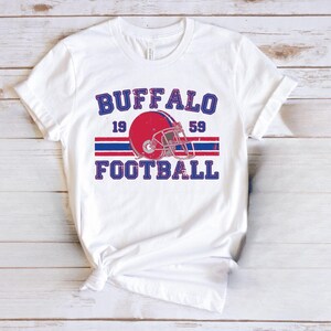 a white shirt with a football helmet on it