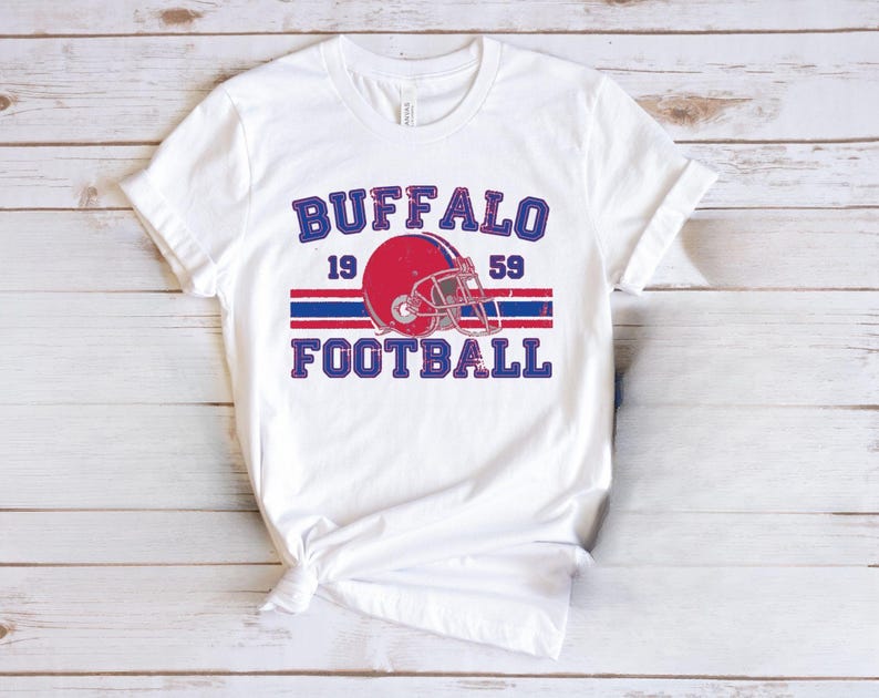 a white shirt with a football helmet on it