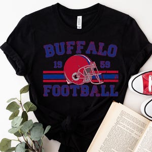 a black shirt with a football helmet on it