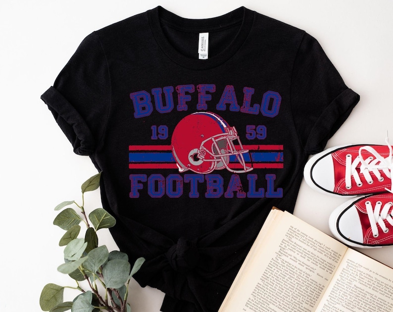 a black shirt with a football helmet on it