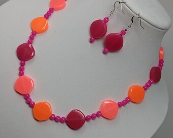 Salmon colored necklace with earrings