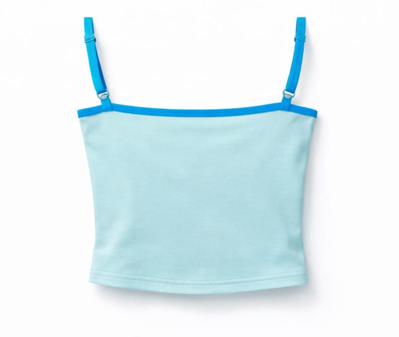 May include: A light blue camisole top with adjustable bright blue straps and trim. The top is a solid color and has a simple, classic design. The straps are thin and attach to the top with metal hardware.