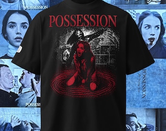 May include: A black short-sleeve t-shirt featuring the word POSSESSION in red text at the top. The center graphic depicts a person kneeling in a red circular pool with a dark, shadowy figure looming behind them in a tiled room setting.