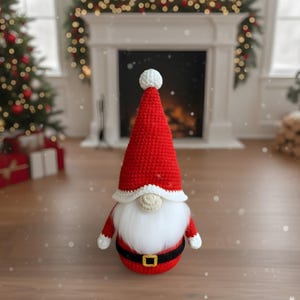 May include: A handmade Christmas gnome doll with a red crocheted hat and body, white beard, and black belt with a gold buckle. The gnome has white trim on the hat and arms. The doll is a festive holiday decoration.