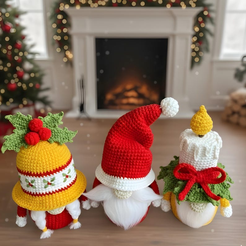 May include: Three handmade crochet Christmas gnomes. One gnome wears a yellow hat with holly, another a red Santa hat, and the third a candle-shaped hat. Each gnome has a white beard and is decorated with red and green accents. Festive holiday decor.