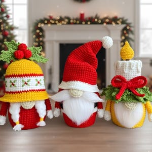May include: Three handmade Christmas gnomes. The gnomes are crocheted in red, yellow, white, and green. One gnome wears a Santa hat, another a yellow hat with holly, and the third is a candle. The gnomes have white beards and are decorated for the holidays.
