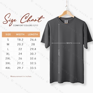 May include: A dark gray Comfort Colors 1717 t-shirt hanging on a wooden hanger. A size chart shows measurements in inches for sizes S to 4XL. The chart includes width and length measurements.