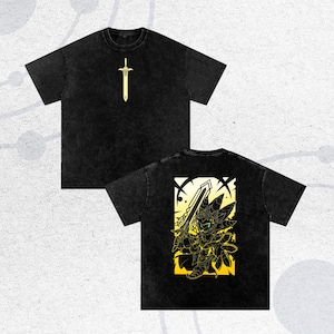 May include: Black t-shirts with a yellow sword graphic on the front and a yellow and black character design on the back. The shirts have a vintage, washed appearance. The design features a sword and a character with a sword.