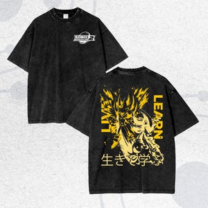 May include: Black, oversized t-shirt with a faded, vintage look. The front features a small logo that says "SONIC ADVENTURE 2". The back displays a yellow graphic of a character with the words "LIVE LEARN" and Japanese text.