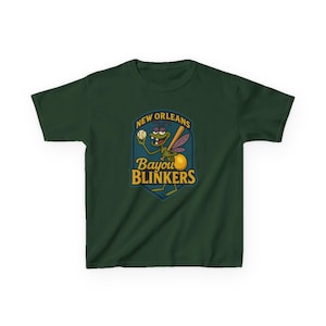 May include: Dark green t-shirt featuring a cartoon firefly holding a baseball bat and ball. The design includes the text "New Orleans Bayou Blinkers" in a shield-shaped emblem. The firefly has a baseball cap and wings.