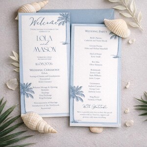 May include: Wedding invitation suite with a light blue and white color scheme. The invitation features the names "Lola and Mason" and the date "16.08.2026". Palm tree illustrations and seashells add a tropical theme.