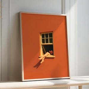 Puede incluir: Impresión artística enmarcada que presenta una pared naranja con una ventana amarilla. La obra de arte representa piernas colgando de la ventana, con un libro visible en el interior. La impresión se exhibe sobre un banco de color claro contra una pared blanca.