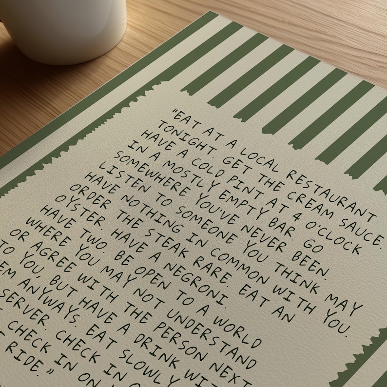 Striped Anthony Bourdain typography poster with handwritten text on a warm cream background featuring olive green, navy blue, and charcoal black colour variations. Vintage-inspired kitchen wall art with subtle stripe details and European cafe aesthetic displayed in wooden frames inside cozy interiors. Minimal quote print designed for coffee corners, dining rooms, bookstores, restaurants, and modern apartments with warm lighting and neutral decor styling.