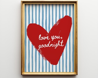 May include: Framed print featuring a red heart with the words "love you, goodnight" in white script. The background has blue and white vertical stripes. The frame is gold-colored.