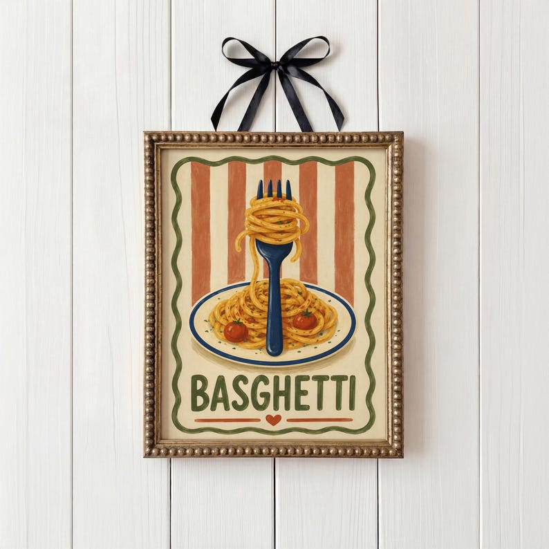 May include: A framed picture of spaghetti on a plate with two tomatoes and a fork. The background has orange and cream stripes. The word "BASGHETTI" is at the bottom. A black ribbon is at the top.