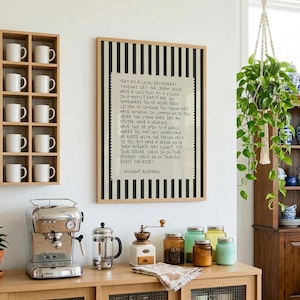 Striped Anthony Bourdain typography poster with handwritten text on a warm cream background featuring olive green, navy blue, and charcoal black colour variations. Vintage-inspired kitchen wall art with subtle stripe details and European cafe aesthetic displayed in wooden frames inside cozy interiors. Minimal quote print designed for coffee corners, dining rooms, bookstores, restaurants, and modern apartments with warm lighting and neutral decor styling.