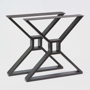 May include: Two dark brown metal table legs with an X-shaped design. The legs have a modern, geometric style, with square supports and angled beams. The top of each leg has a flat surface for attaching a tabletop.