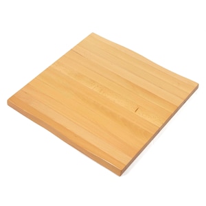 May include: A square wooden board constructed from multiple light-colored, smooth-finished planks joined together. The surface displays a natural grain pattern with subtle variations in tone, featuring a clean, flat, and uniform design.