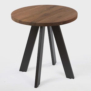 May include: A round side table with a dark wood top and black metal legs. The table has a simple, modern design, suitable for a living room or bedroom. The table's diameter is approximately 24 inches.