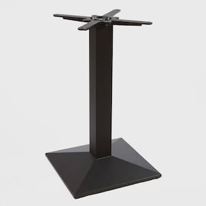 May include: A black metal table base with a square base and a central column. The top features a four-pronged design for attaching a tabletop. The base measures approximately 20 inches square and the column is about 28 inches tall.